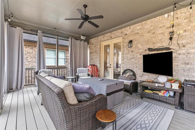 wooden deck with ceiling fan, an outdoor hangout area, and french doors