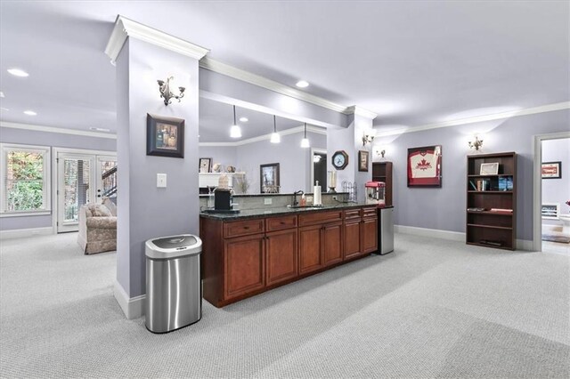 kitchen featuring pendant lighting, french doors, sink, ornamental molding, and light colored carpet