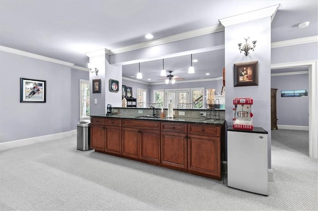 kitchen with ceiling fan, crown molding, and light carpet