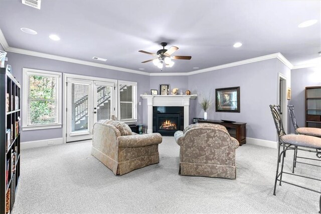 living room with french doors, light colored carpet, ceiling fan, and ornamental molding