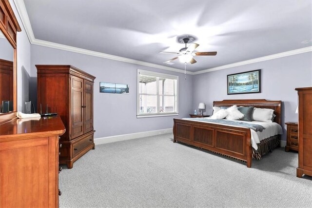 bedroom featuring ceiling fan, light colored carpet, and ornamental molding