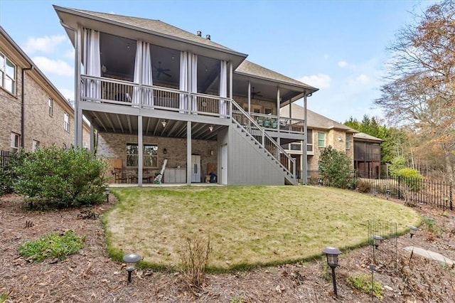 back of property featuring a yard, ceiling fan, and a patio area