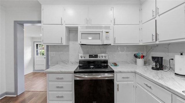 216 Coosawattee Ave SW, Rome, GA 30165 - kitchen featuring white microwave, stainless steel range with electric stovetop, wood finished floors, tasteful backsplash, and white cabinetry