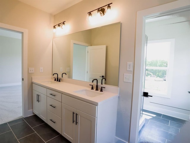1415 Coretta Bnd, Atlanta, GA 30318 - bathroom with tile patterned flooring, double vanity, and baseboards