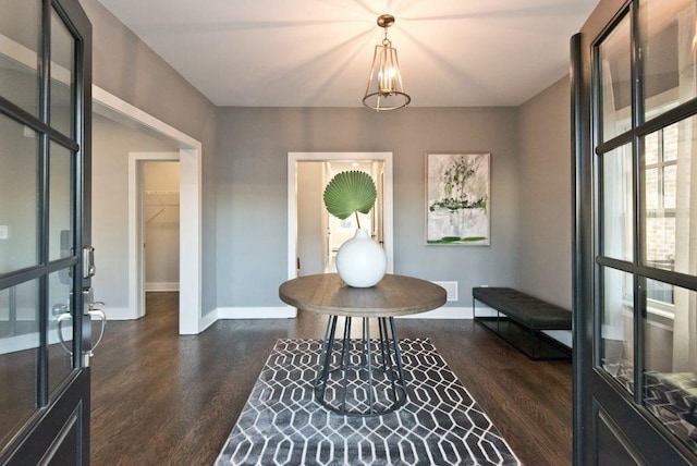 entryway with baseboards, dark wood-style floors, and visible vents