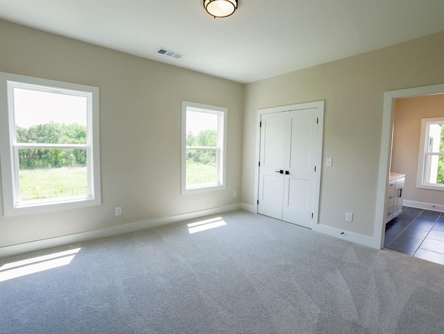 1415 Coretta Bnd, Atlanta, GA 30318 - unfurnished bedroom featuring dark carpet, baseboards, and ensuite bath