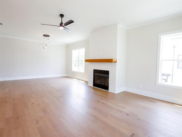 1415 Coretta Bnd, Atlanta, GA 30318 - unfurnished living room featuring ornamental molding, light wood-style flooring, a fireplace, a ceiling fan, and baseboards