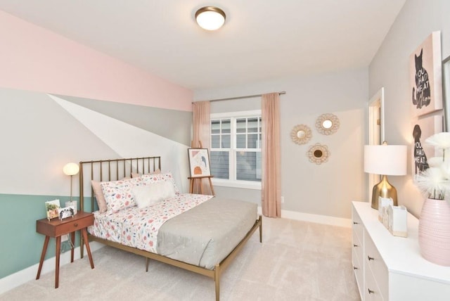 bedroom with baseboards and light colored carpet