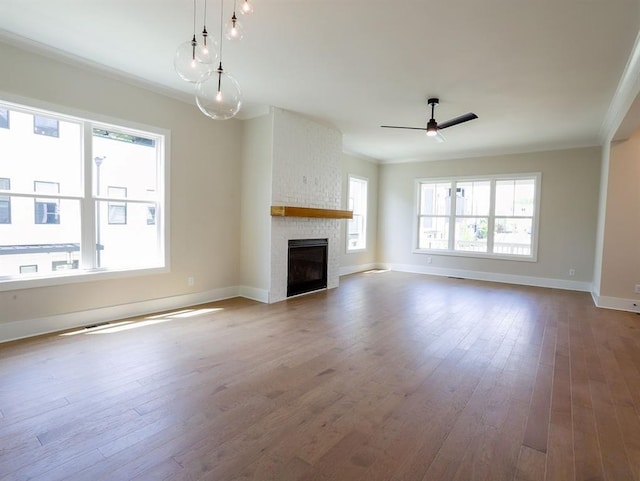 1415 Coretta Bnd, Atlanta, GA 30318 - unfurnished living room featuring ceiling fan, a large fireplace, baseboards, wood-type flooring, and crown molding