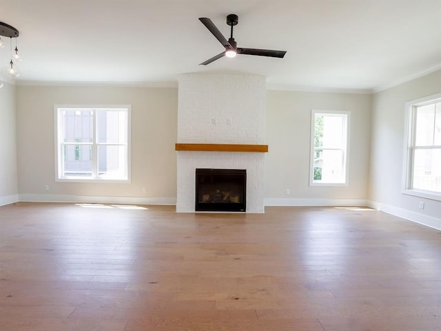 1415 Coretta Bnd, Atlanta, GA 30318 - unfurnished living room featuring ornamental molding, a ceiling fan, a fireplace, wood finished floors, and baseboards