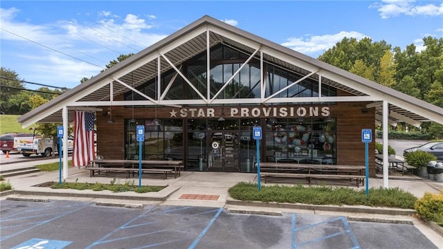 view of building exterior with uncovered parking