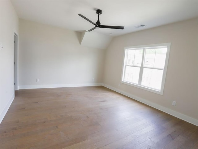 1415 Coretta Bnd, Atlanta, GA 30318 - spare room featuring a ceiling fan, hardwood / wood-style floors, baseboards, and vaulted ceiling