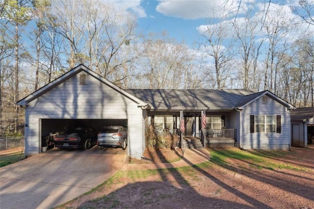 view of front of house with driveway, an attached garage, and a porch