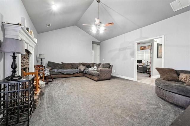 living area featuring lofted ceiling, carpet floors, visible vents, and a stone fireplace