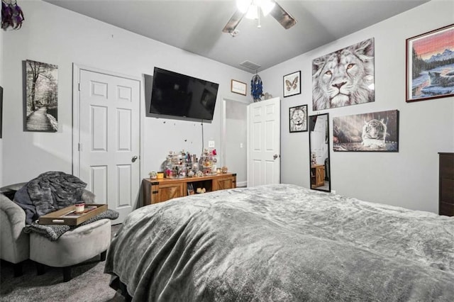 bedroom featuring a ceiling fan, visible vents, and carpet flooring