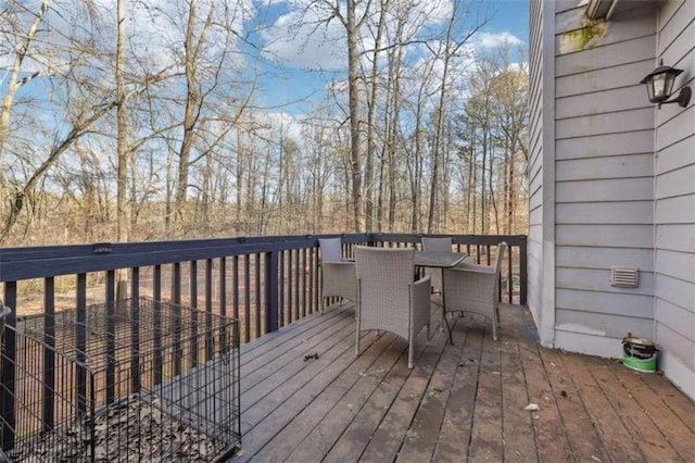 wooden terrace featuring outdoor dining area