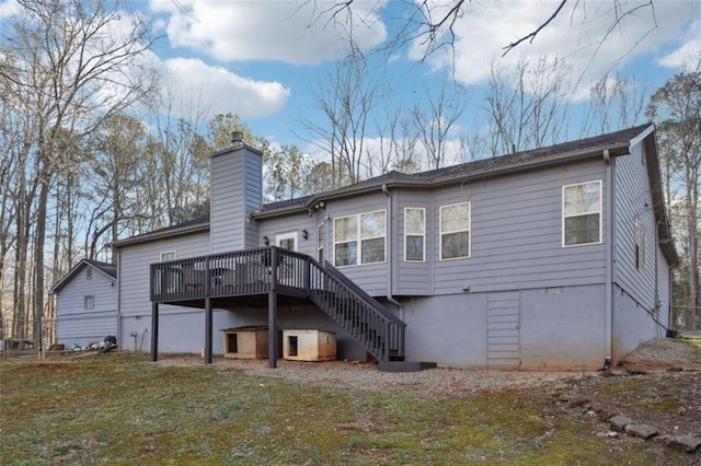 back of house with a yard, a chimney, a wooden deck, and stairs