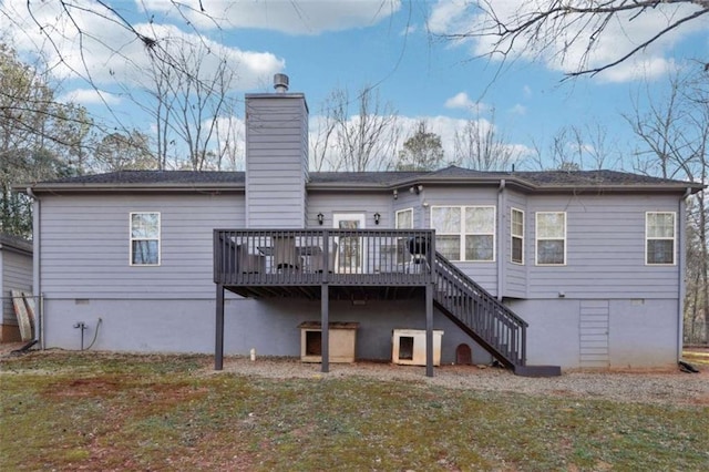 rear view of property with a deck, a chimney, and stairs