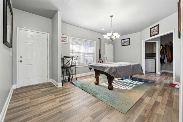 game room featuring washer / dryer, billiards, baseboards, and light wood finished floors