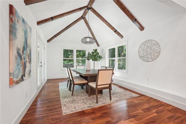 dining room with dark wood finished floors, beamed ceiling, a healthy amount of sunlight, and baseboards