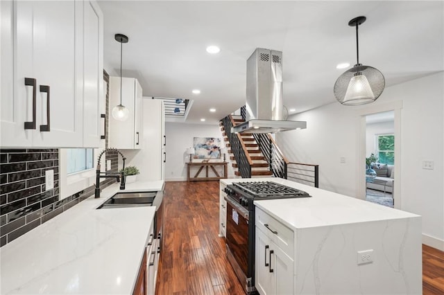 kitchen featuring island exhaust hood, a sink, tasteful backsplash, dark wood-style floors, and stainless steel gas range