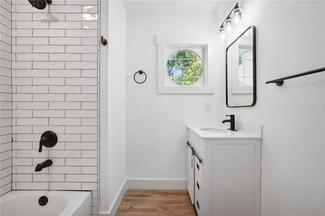 full bathroom featuring vanity, shower / tub combination, wood finished floors, and baseboards