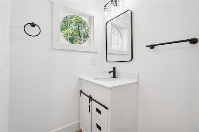 bathroom with vanity and baseboards