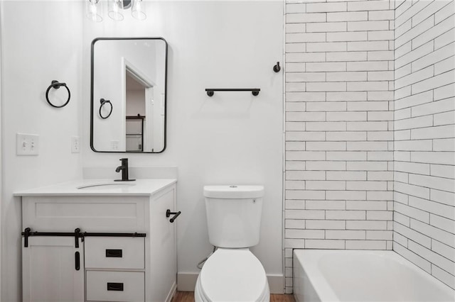 bathroom featuring toilet, vanity, and  shower combination