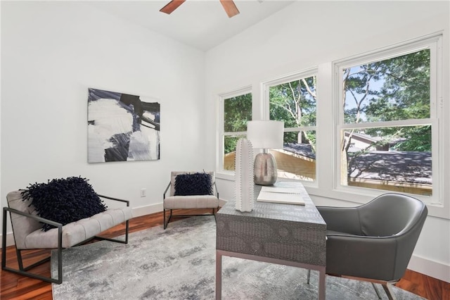 office area with ceiling fan, baseboards, and wood finished floors