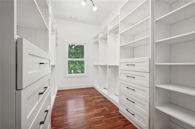 spacious closet with dark wood finished floors and visible vents