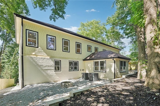 rear view of property with brick siding and cooling unit