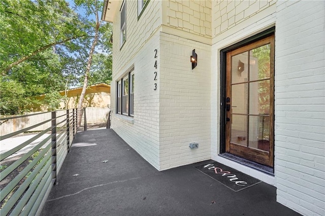 property entrance featuring brick siding