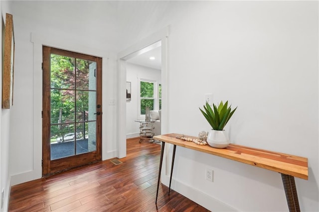 entryway with dark wood finished floors and recessed lighting