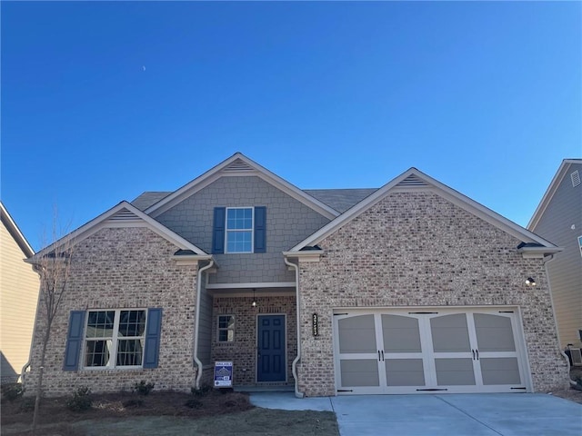 view of front of property featuring a garage, driveway, and brick siding