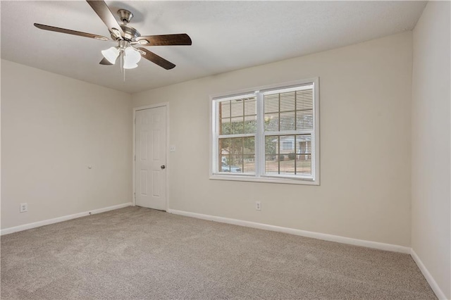 unfurnished room featuring ceiling fan and carpet flooring