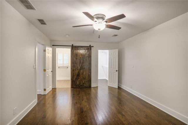 3323 Lancing Ct, Duluth, GA 30096 - unfurnished bedroom featuring baseboards, dark wood finished floors, a barn door, and a ceiling fan