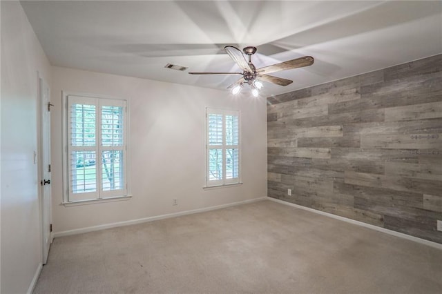 3323 Lancing Ct, Duluth, GA 30096 - spare room with wooden walls, healthy amount of natural light, ceiling fan, light colored carpet, and baseboards