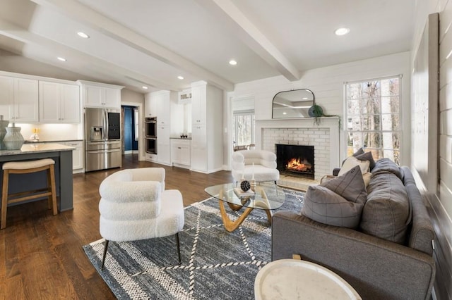 living area with plenty of natural light, a fireplace, and dark wood-style flooring