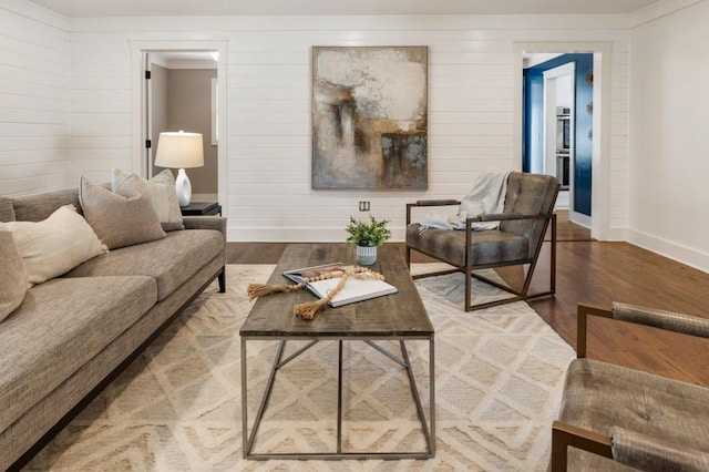 living room featuring baseboards and wood finished floors