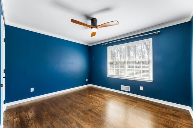 spare room featuring visible vents, wood finished floors, crown molding, baseboards, and ceiling fan