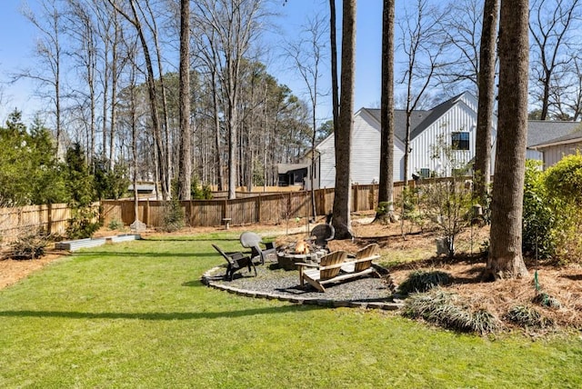 view of yard with a fire pit and fence