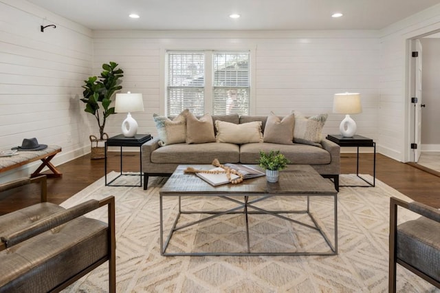 living room with recessed lighting, baseboards, and wood finished floors