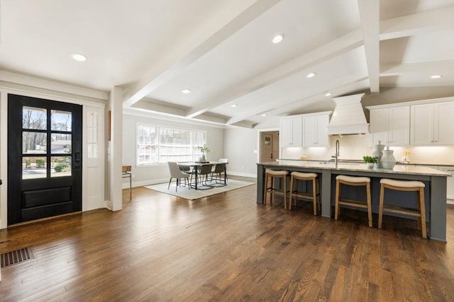 entrance foyer with visible vents, baseboards, dark wood finished floors, lofted ceiling with beams, and recessed lighting