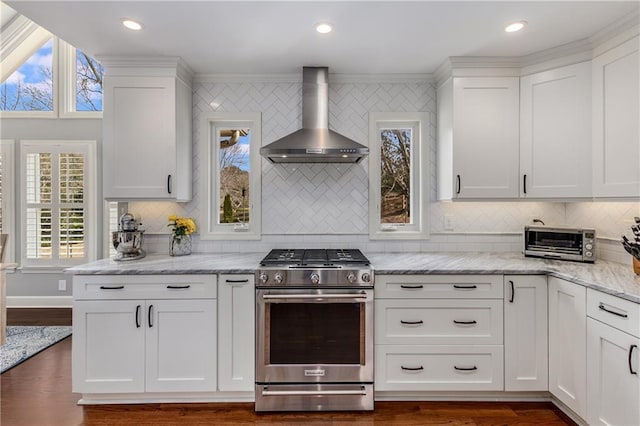 kitchen featuring light stone counters, a toaster, white cabinetry, stainless steel gas range, and wall chimney exhaust hood