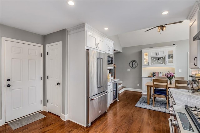 kitchen with premium appliances, recessed lighting, white cabinetry, and dark wood-style floors