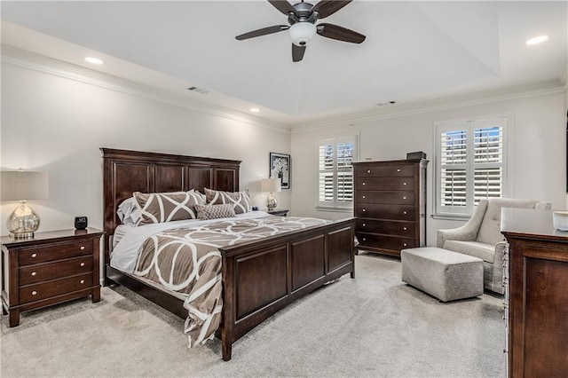 bedroom featuring multiple windows, a tray ceiling, ornamental molding, and light colored carpet