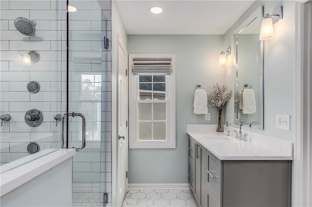 full bathroom featuring baseboards, a shower stall, and vanity