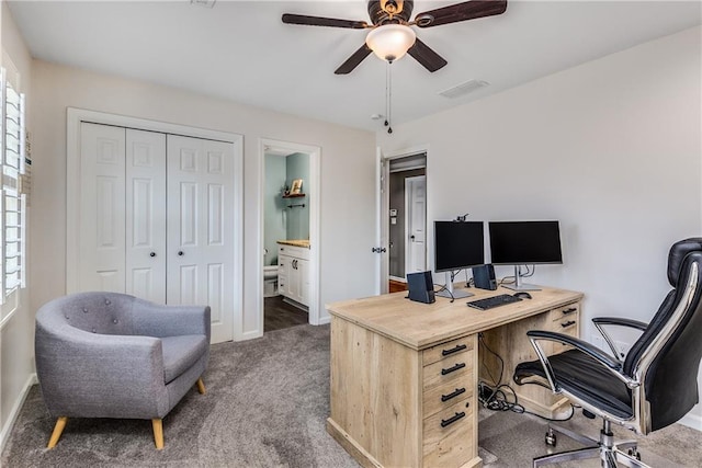 carpeted office with ceiling fan, visible vents, and baseboards