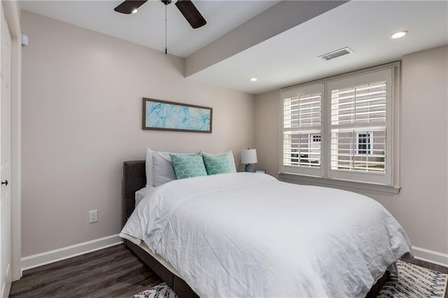 bedroom with baseboards, visible vents, dark wood-type flooring, and recessed lighting