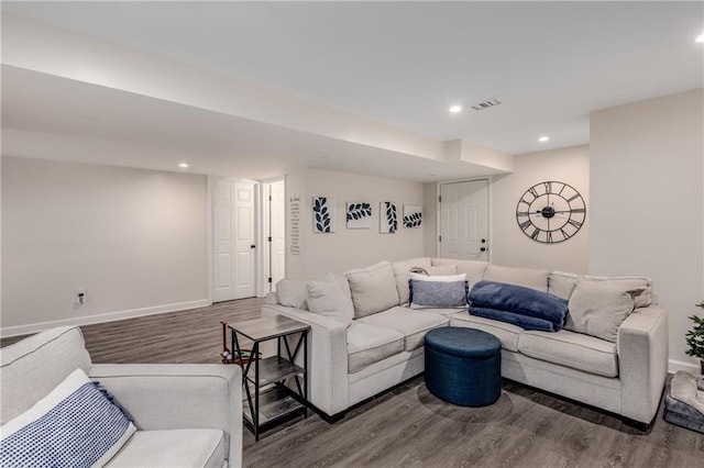 living area with recessed lighting, wood finished floors, visible vents, and baseboards